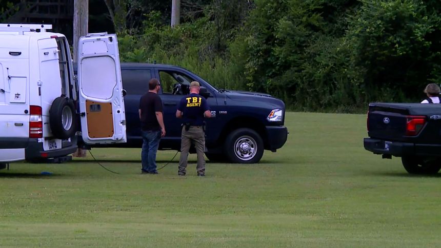 Law enforcement search an area in Jackson, Tennessee, on Monday.