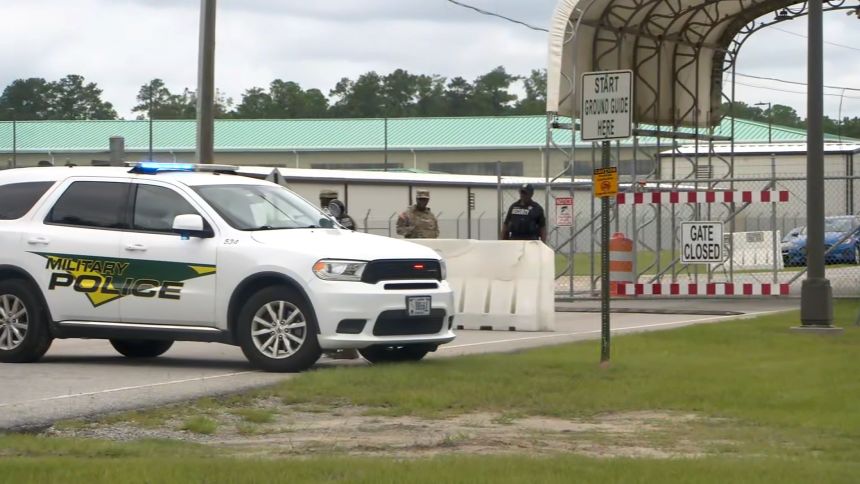 Military police are seen at a gate at Fort Stewart in Georgia on Wednesday.