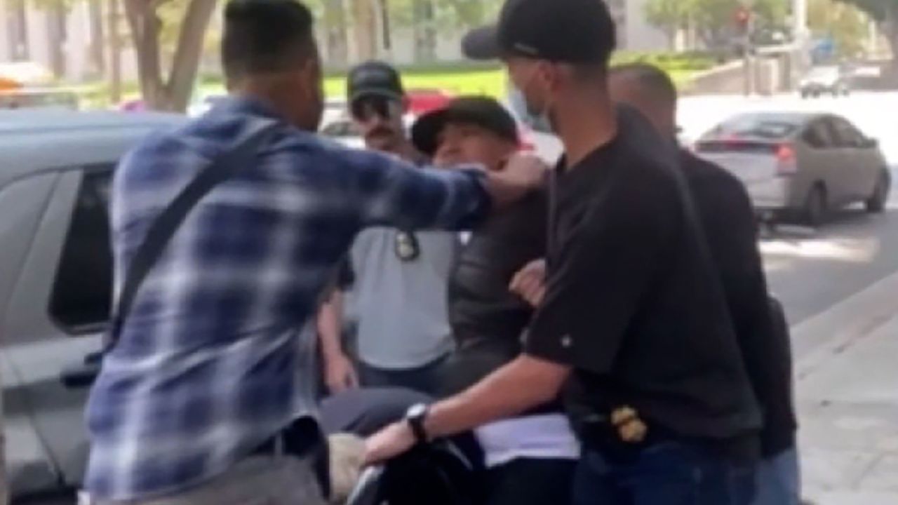 The man was detained outside a Los Angeles courthouse on Wednesday by a group of men, some of whom wore masks, video showed.