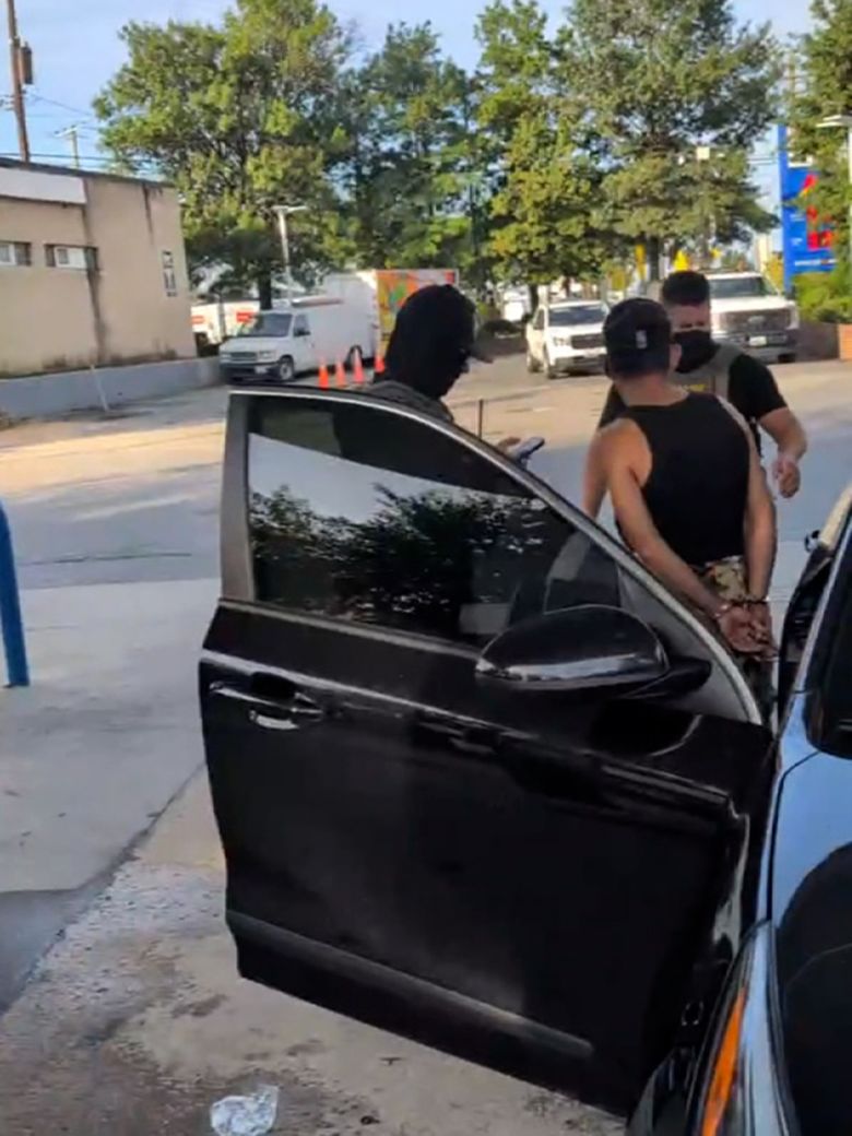 ICE agents detain the man.