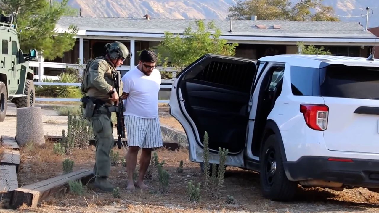 Jake Haro is seen being arrested at their home on Friday in Cabazon, California.