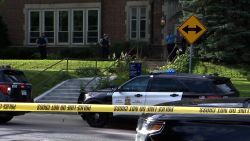 Police stand guard at the scene of a shooting in Minneapolis on Wednesday.