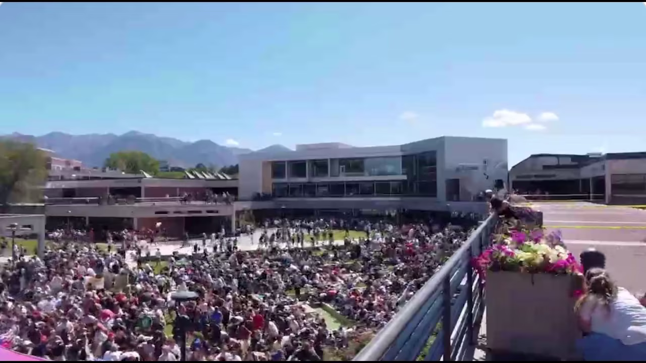 This screengrab taken from a social media video shows people running after Charlie Kirk was shot at Utah Valley University, on Wednesday.