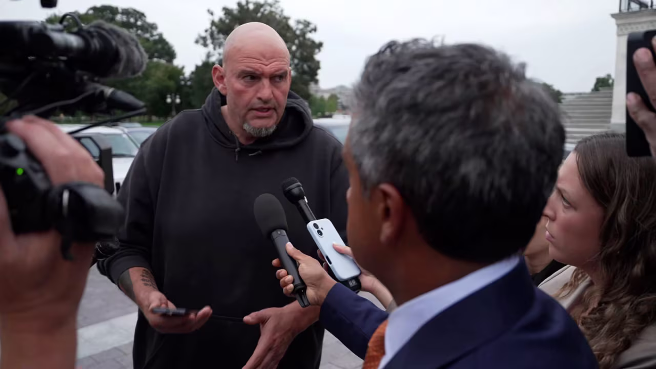 Sen. John Fetterman talks with members of the media on Monday.