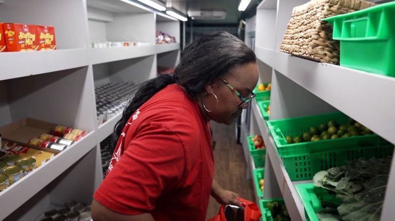 Bashtye Bailey, a Navy wife and veteran, looks through a food bank for military families near Naval Station Norfolk. 