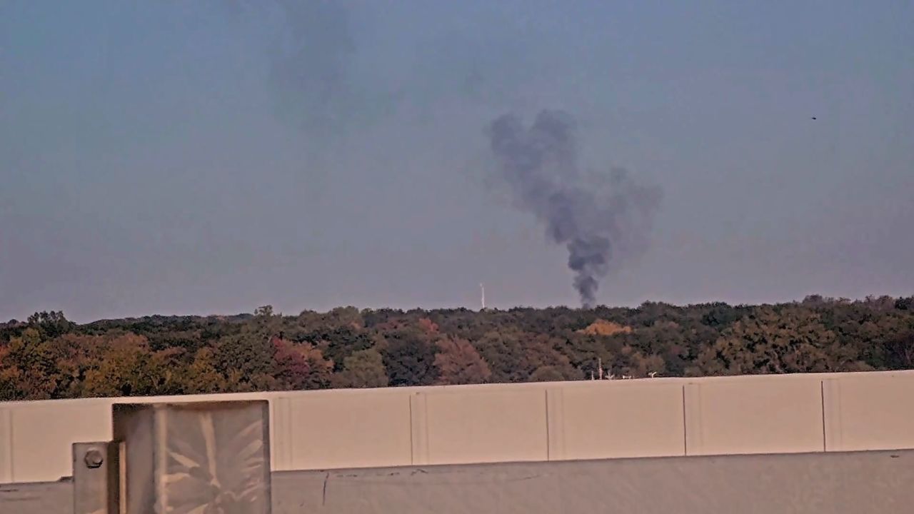 Smoke rises from the site of a Hawker 800 plane crash in Bath, Michigan, on October 16.
