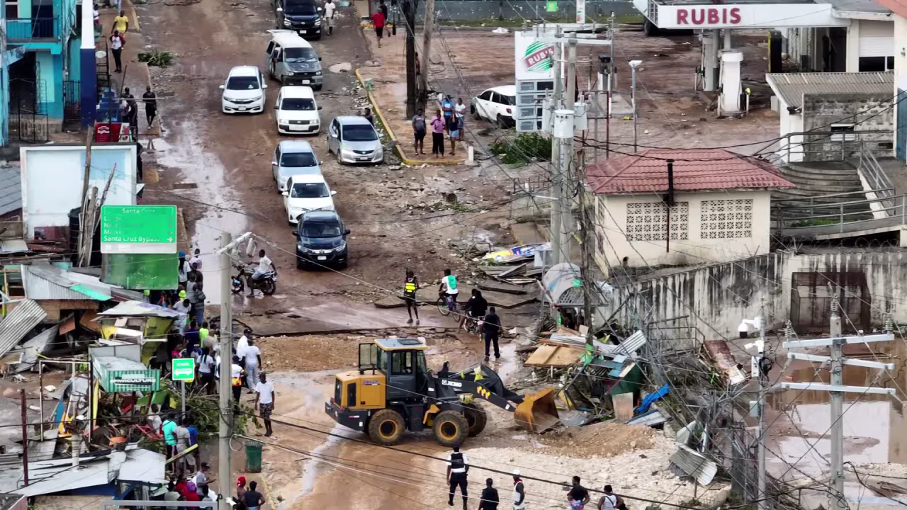 Debris is cleared from a road in Santa Cruz, Jamaica, on October 29.