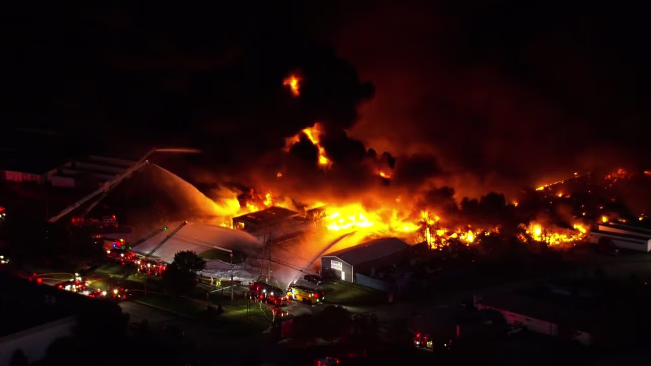 Firefighters work to extinguish flames from a plane crash in Louisville, Kentucky, on Tuesday.
