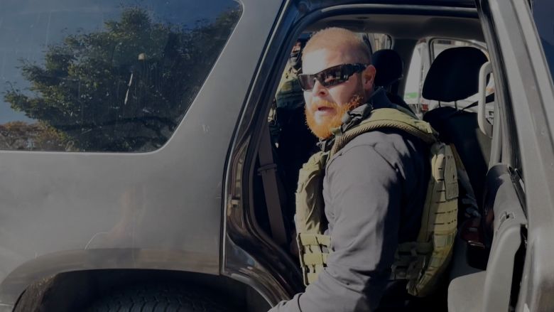 A still from a video shot by Evanston resident David Brooks shows a federal officer take notice of him filming.