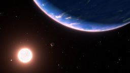 This is an artist's concept of the exoplanet GJ 9827d, the smallest exoplanet where water vapor has been detected in the atmosphere. The planet could be an example of potential planets with water-rich atmospheres elsewhere in our galaxy. With only about twice Earth's diameter, the planet orbits the red dwarf star GJ 9827. Two inner planets in the system are on the left. The background stars are plotted as they would be seen to the unaided eye looking back toward our Sun. The Sun is too faint to be seen. The blue star at upper right is Regulus; the yellow star at center bottom is Denebola; and the blue star at bottom right is Spica. The constellation Leo is on the left, and Virgo is on the right. Both constellations are distorted from our Earth-bound view from 97 light-years away.