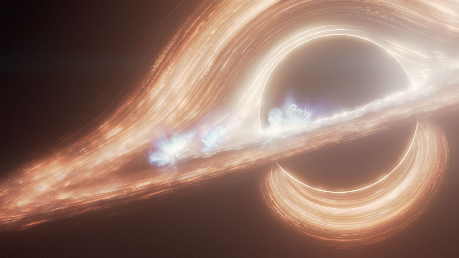 An artist’s illustration depicts the supermassive black hole at the center of the Milky Way galaxy, known as Sagittarius A*. It’s surrounded by a swirling accretion disk of hot gas and dust.