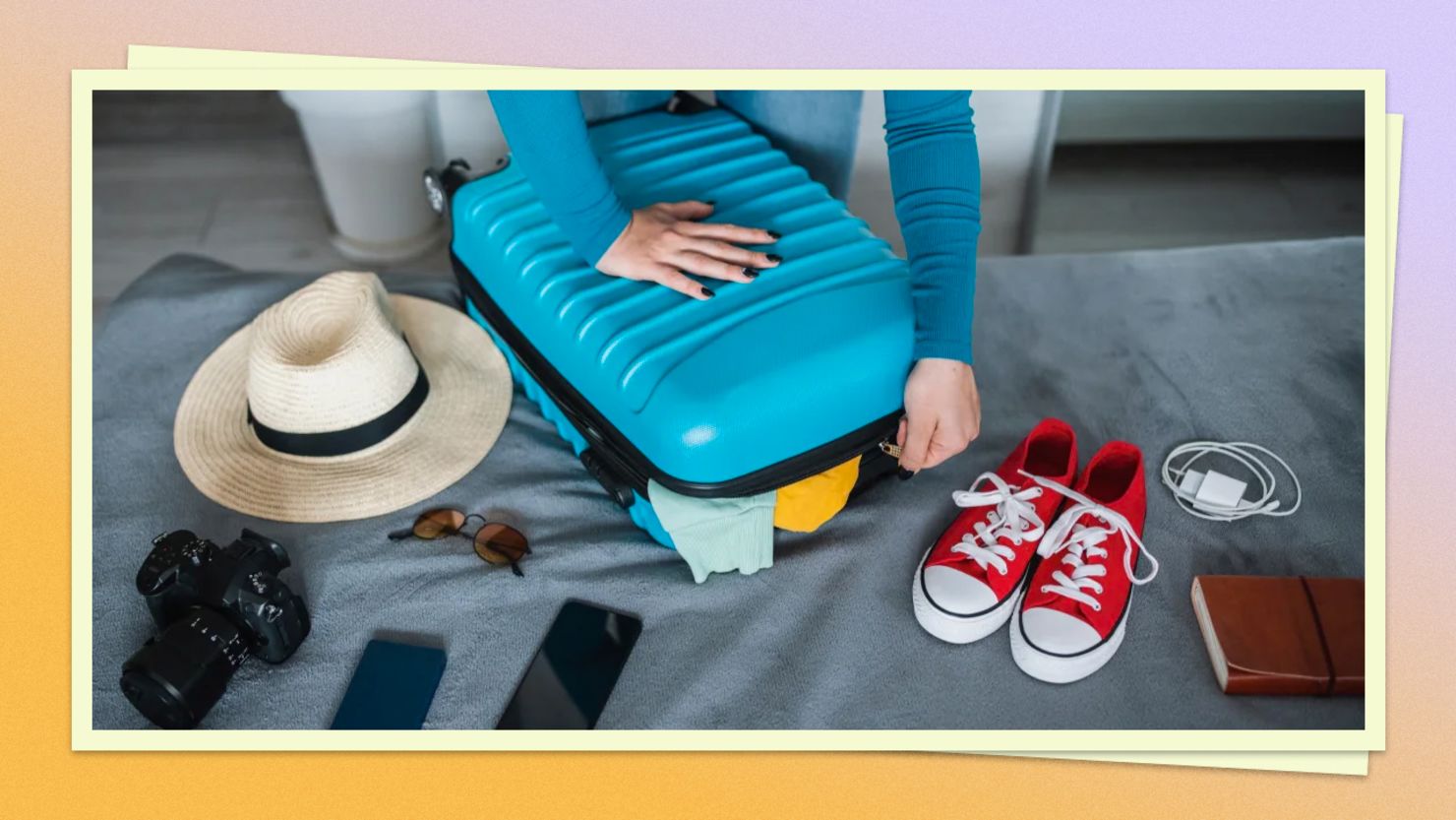 A photo of a person packing a suitcase on a bed with various items scattered around