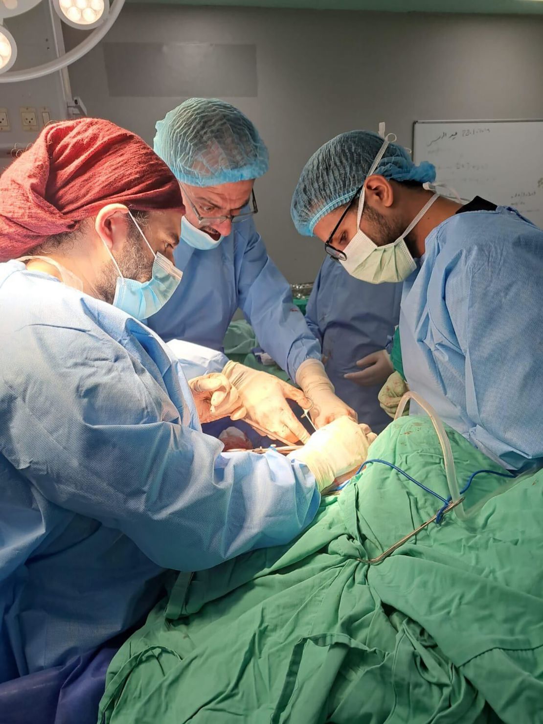 Jiab Suleiman, center, performs surgery on a man who was shot in the hip, at the European Hospital in Khan Younis in February.