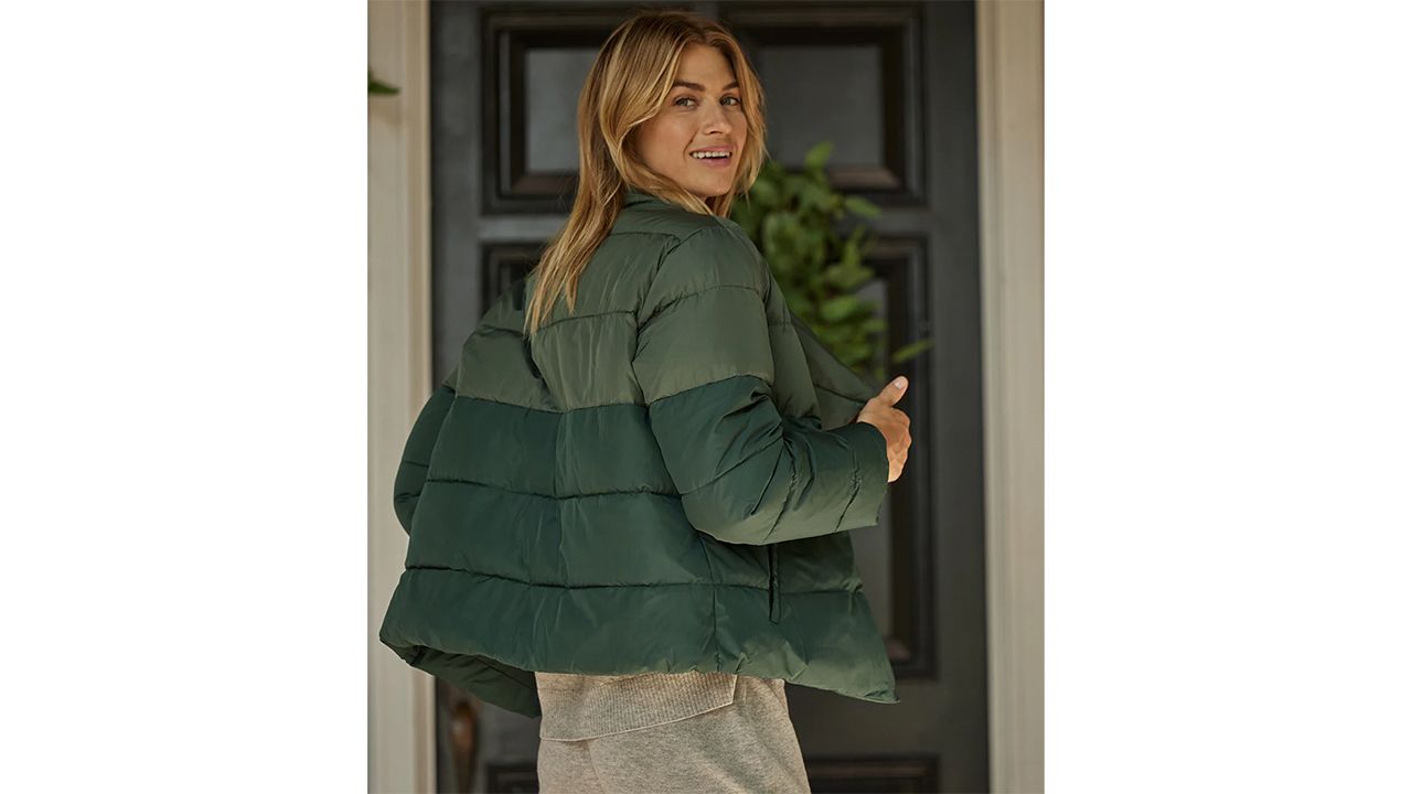 A photo of a person wearing a green The Colorblock Eco Puffer Jacket from Summersalt