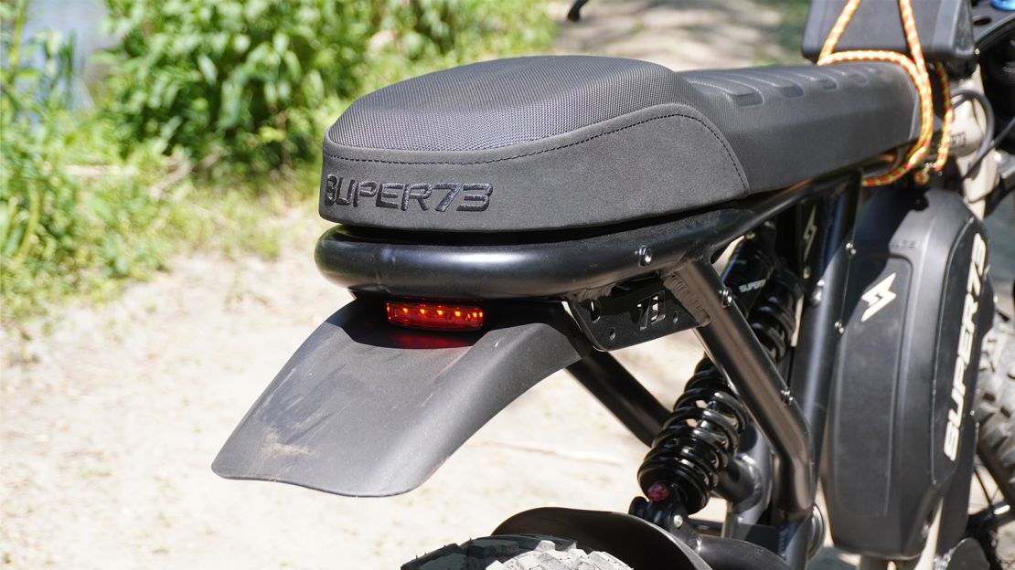 The flat, motorcycle-style saddle is comfortable for tooling around, but the combination of the lack of adjustability of the saddle and the awkward reach to the pedals meant it was hard to find a good position when the terrain got rougher.