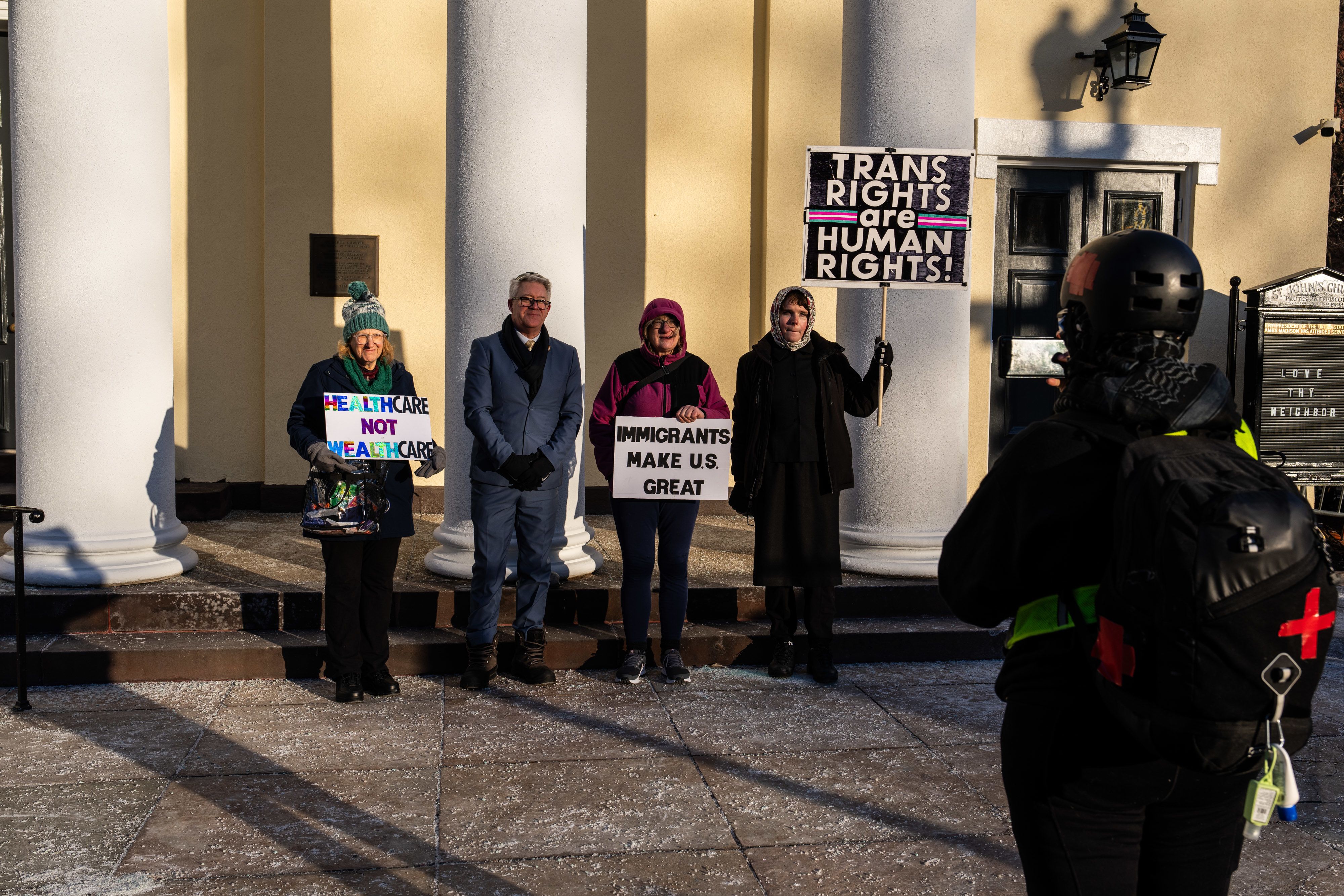 Activists pose for a photo outside of St. John’s Church near the White House.