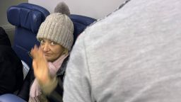 The stowaway identified by French authorities as Svetlana Dali prepares to disembark a flight that arrived in New York on Wednesday. CNN has blurred a portion of this image.
