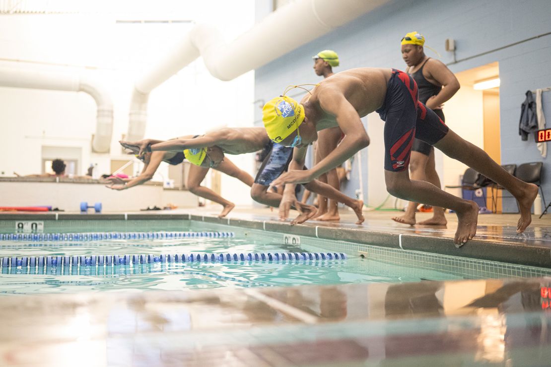 Rocket McDonald (front) and Makos Swim teammates enter the water during practice at the YMCA’s O’Fallon Park Rec Complex on March 18.