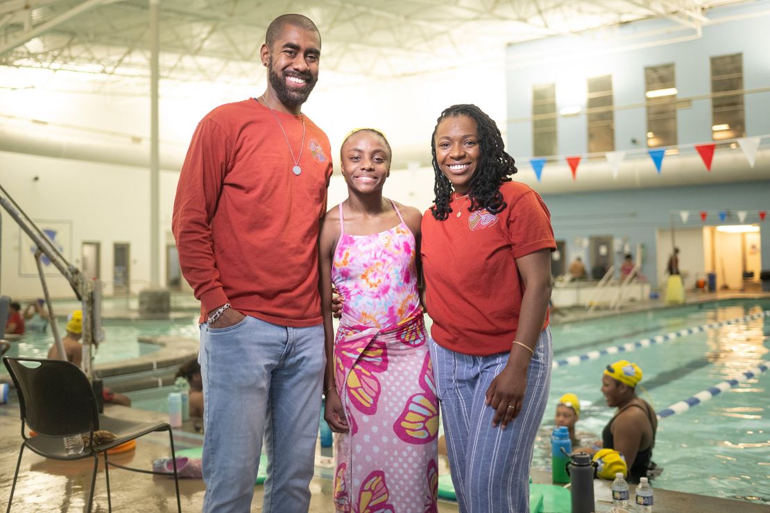 Joshua Crump (left) and his wife, Najma Nasiruddin-Crump (right), stand with Joshua’s daughter Kaia Collins-Crump at the YMCA’s O’Fallon Park Rec Complex on March 18.