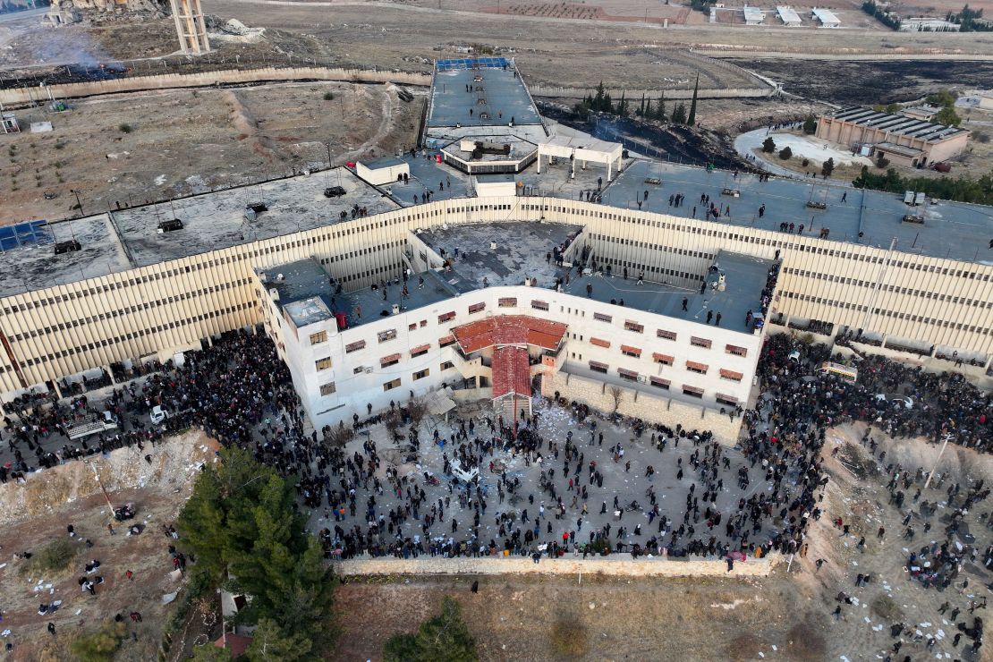 An aerial photo shows people gathering at the Saydnaya prison in Damascus on December 9.