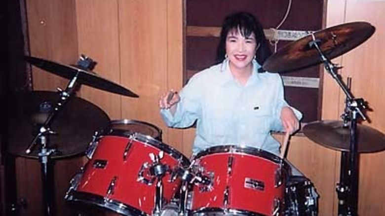 Takaichi is seen playing the drums in an undated photo. She is a fan of heavy metal music.
