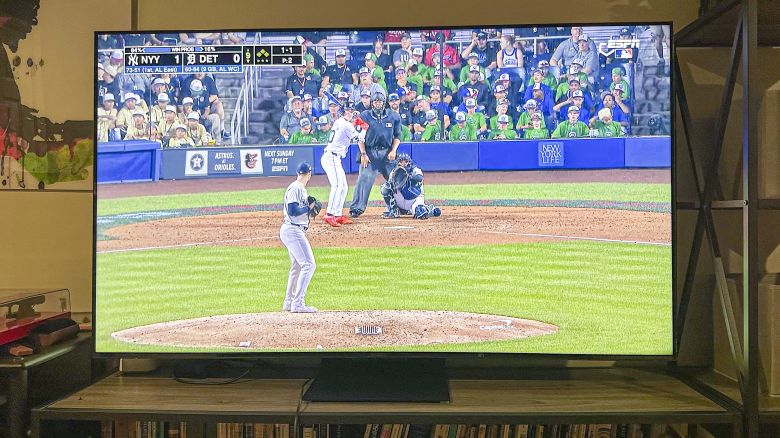 TCL QM8 TV displaying a baseball game.