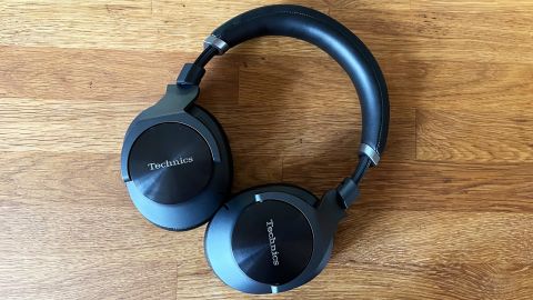 The Technics EAH-A800 Bluetooth headphones, laid flat on a butcher block countertop