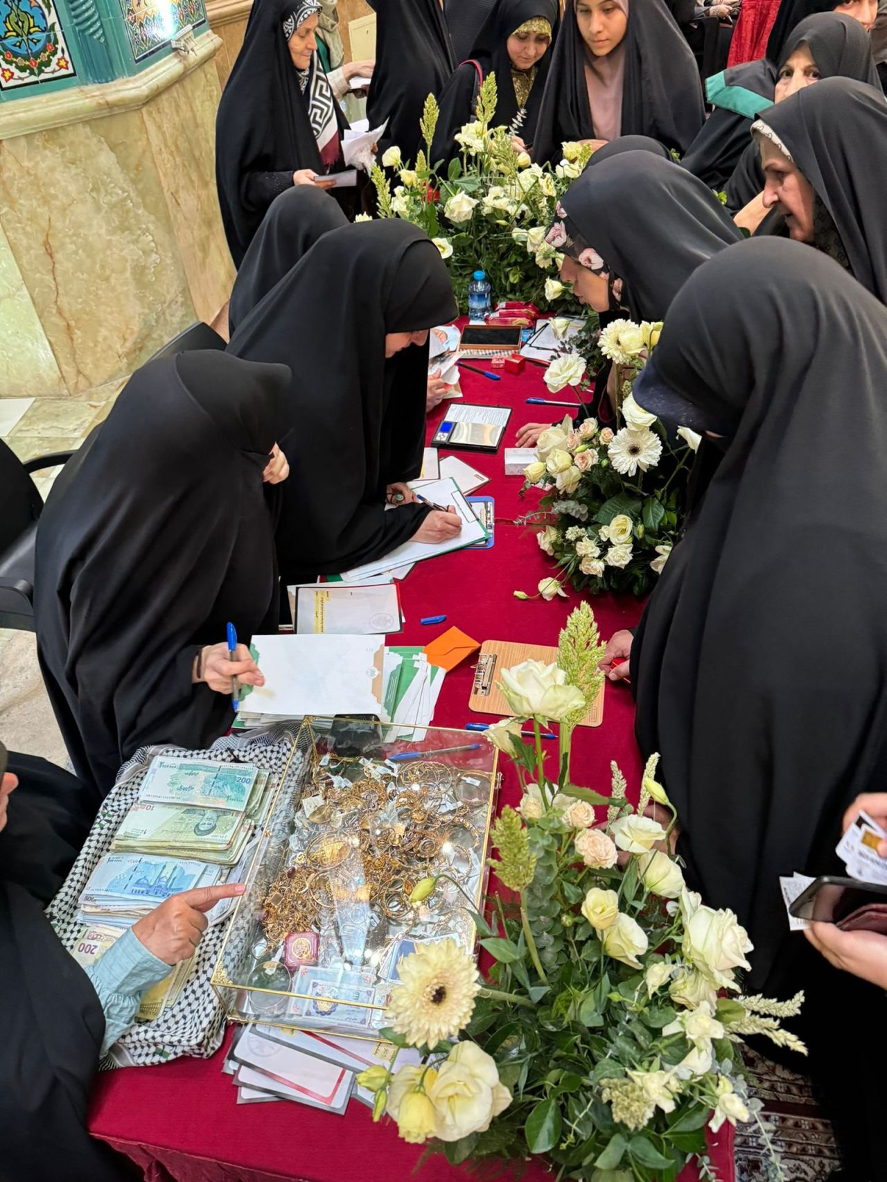 Iranians donate gold to a donation drive for Hezbollah and Lebanon in Tehran, Iran, on Saturday, October 12.