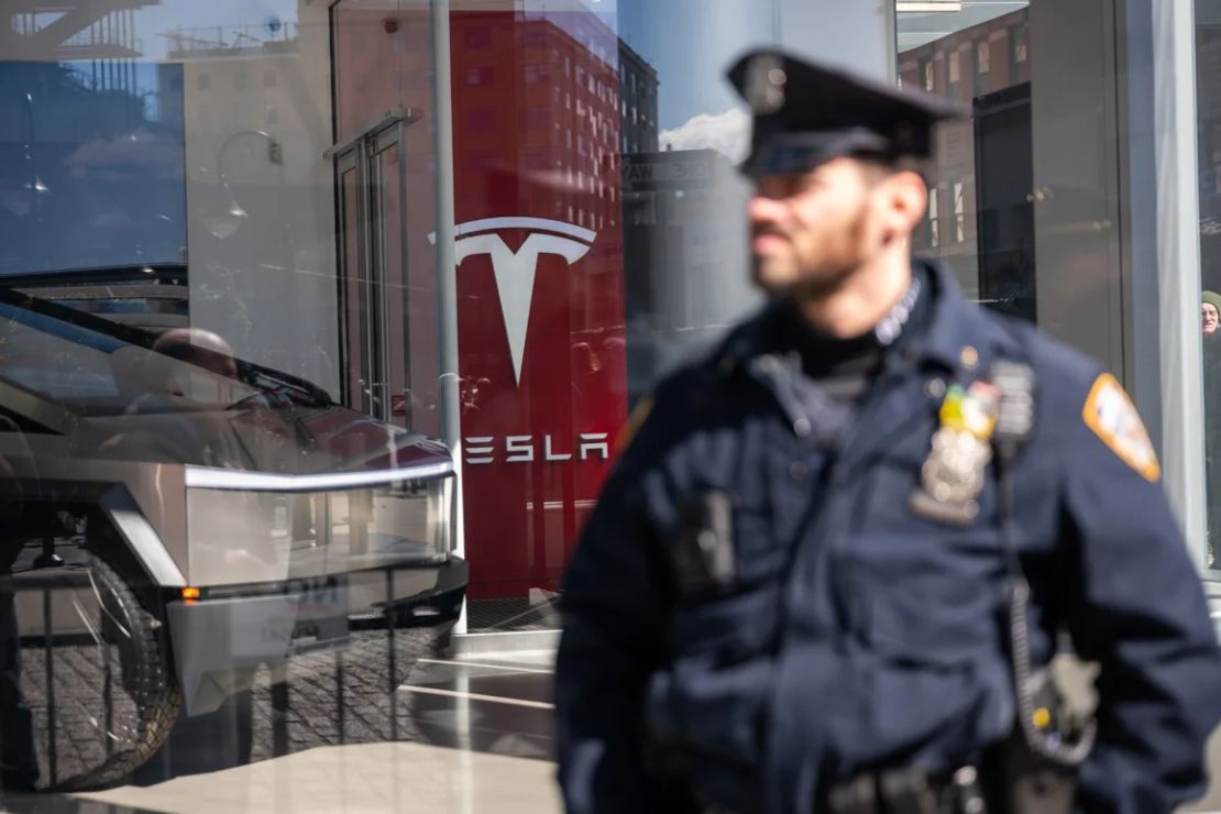 La policía monta guardia mientras los manifestantes se reúnen frente a un concesionario de Tesla en Manhattan para protestar contra el director ejecutivo de Tesla, Elon Musk.