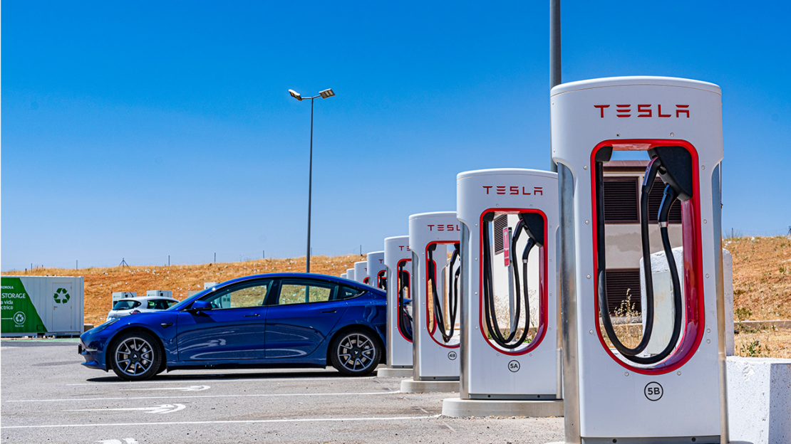 Tesla charging at a supercharger station