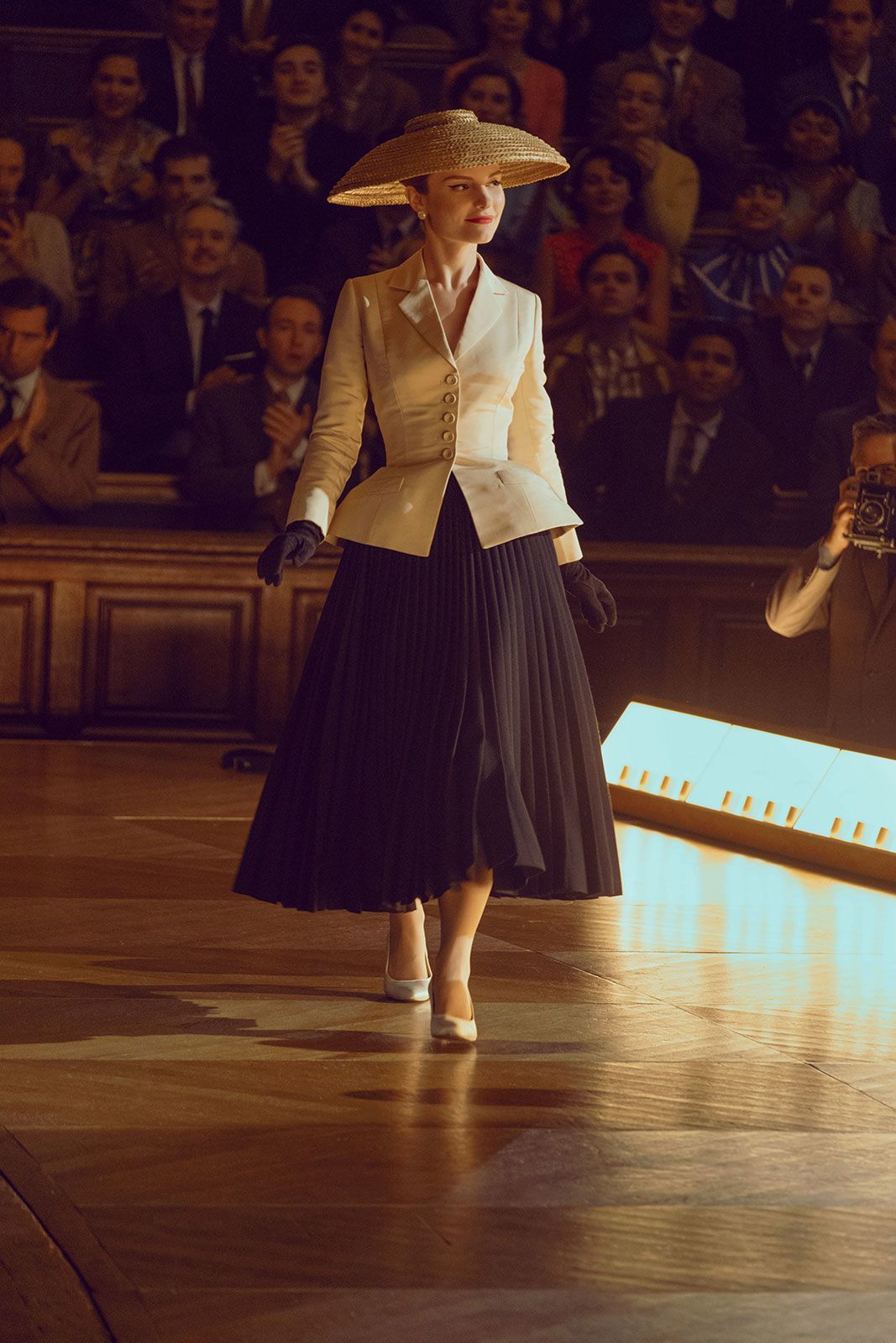 Dior's iconic “Bar” suit, consisting of a full black skirt and voluminous cream blazer that emphasizes the waist and shoulders, with an accompanying wide-brimmed hat, has been copiously referenced in fashion and pop culture.
