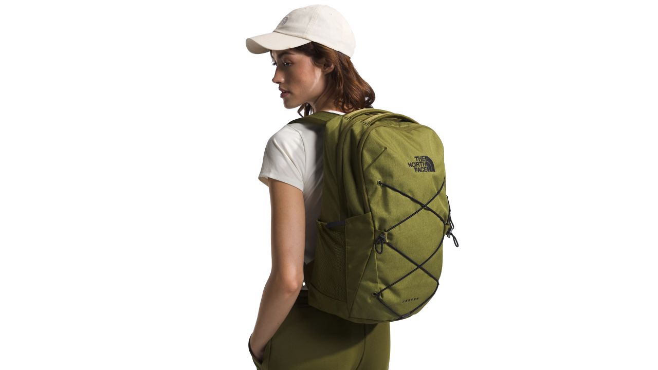 woman wearing the north face jester backpack in Forest Olive Light Heather/TNF Black