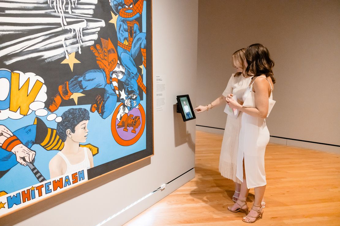 Visitors engage with the artist Melesio Casas' 1973 work "Humanscape 70 (Comic Whitewash)," a piece Jewel chose to represent the 'Seen Plane.'