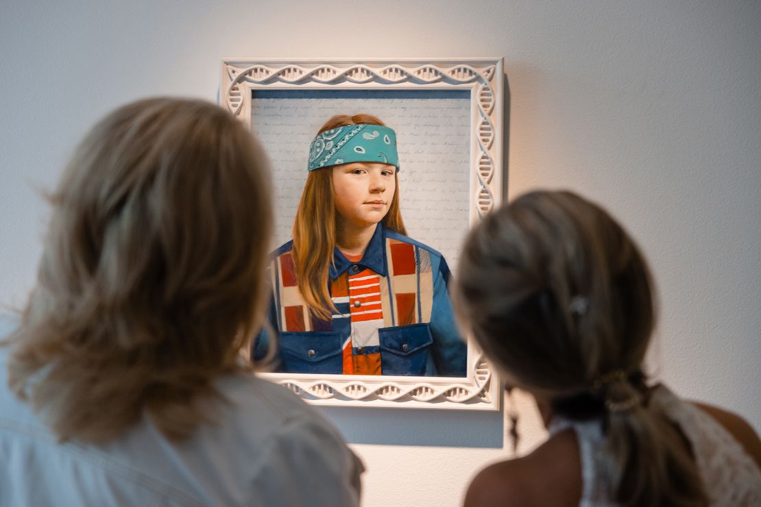 Visitors view Jewel's own work on display: "Double Helix," a portrait of her son, Kase.