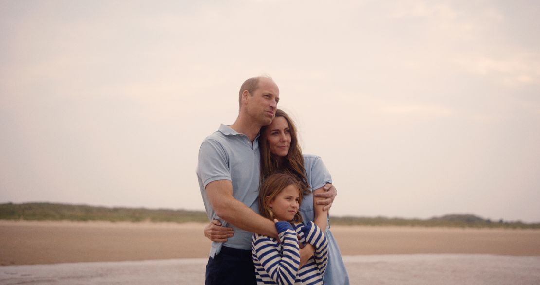 Catherine and William stand with their daughter, Princess Charlotte, on the English coast.