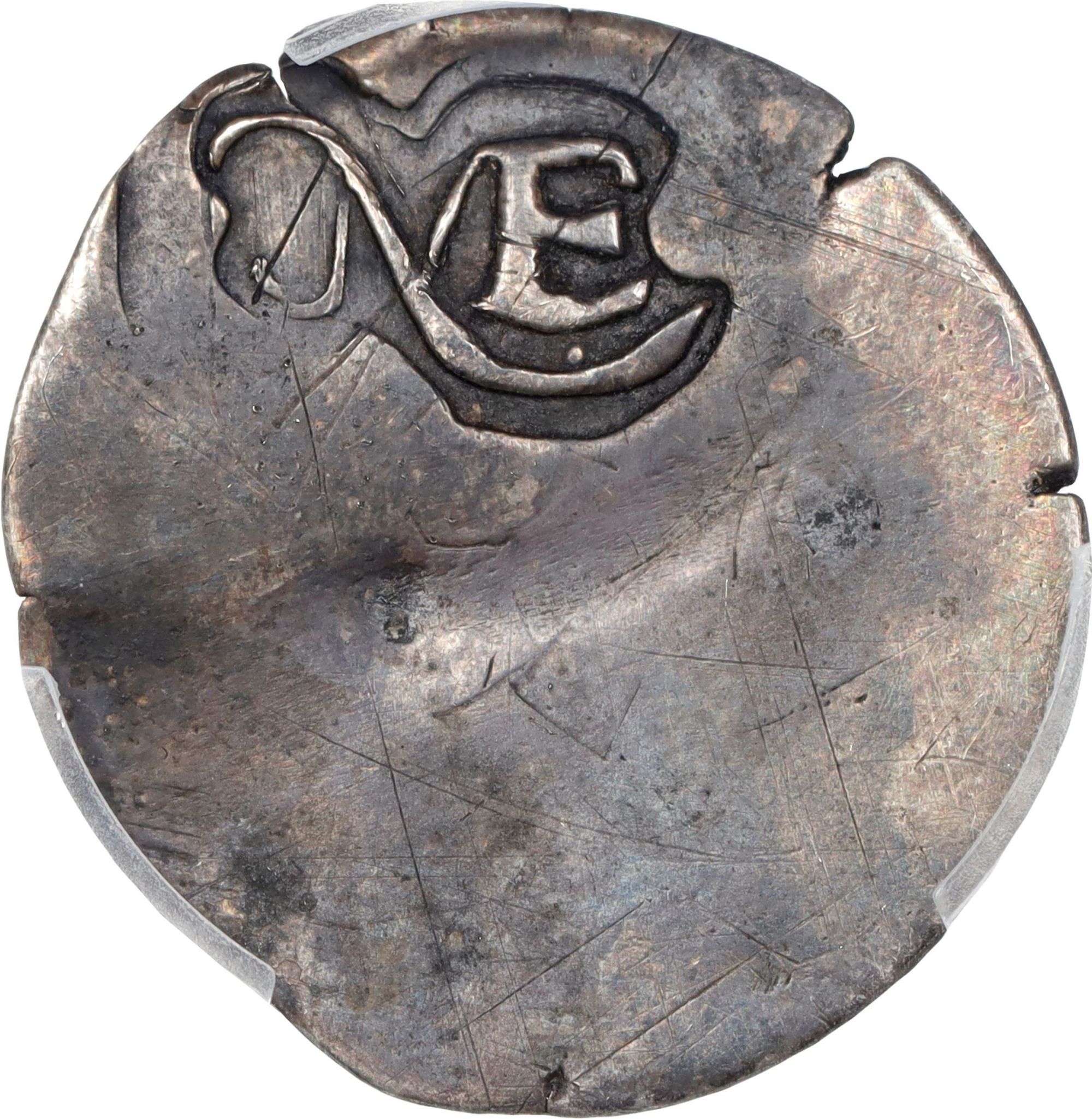 One side of the coin is stamped with NE to signify it was made in New England.