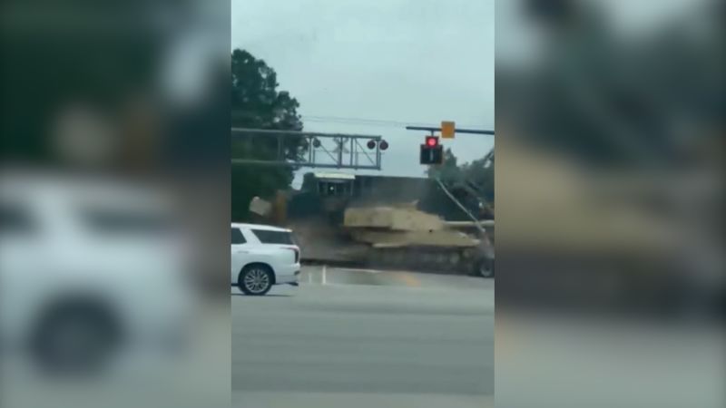 Watch: Train smashes into a semi-truck hauling an armored vehicle