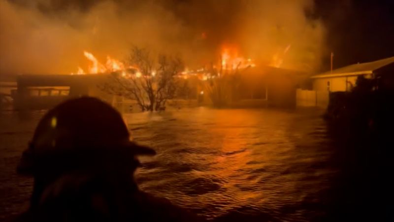 Video shows dramatic footage of first responders passing house on fire