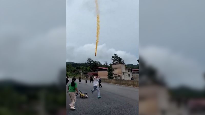 shows suspected Chinese rocket debris falling over village