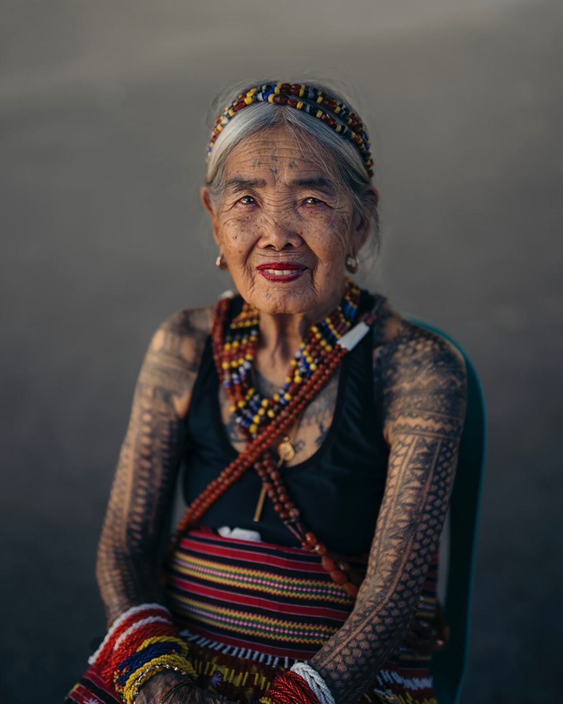 Portrait of Whang-Od dressed in traditional Butbut attire.