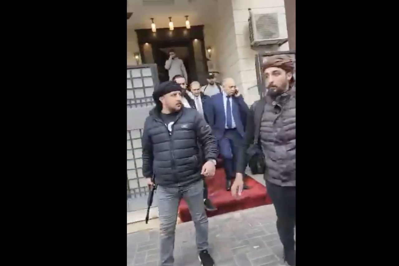 This screengrab from a social media video shows Syrian Prime Minister Mohammad Ghazi Al-Jalali being escorted by rebels in Damascus, Syria, on December 8.