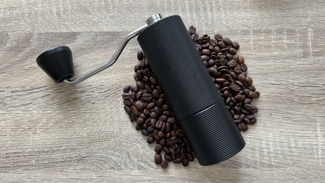 timemore chestnut c3 coffee grinder on a bed of coffee beans