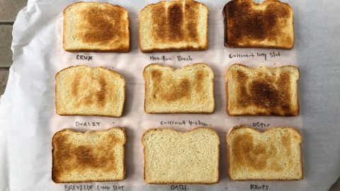 9 slices of toast from the toasters we tested in 2022, showing the range of browning each model creates on a medium setting.