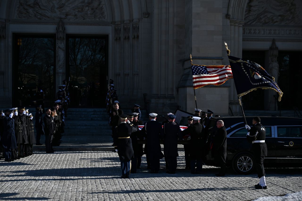 The casket of former President Jimmy Carter is carried out of a hearse in front of the National Cathedral during his state funeral service in Washington, DC, on January 9.