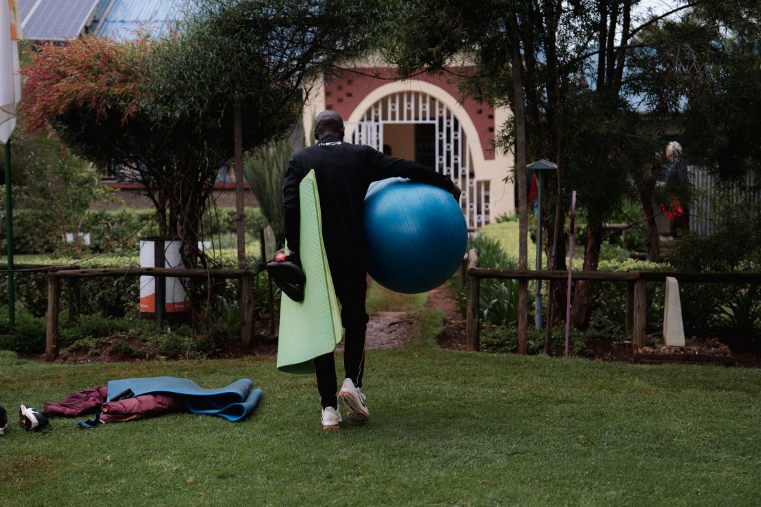 Kipchoge with training equipment at his camp, where life is stripped back to basics in the pursuit of running excellence.