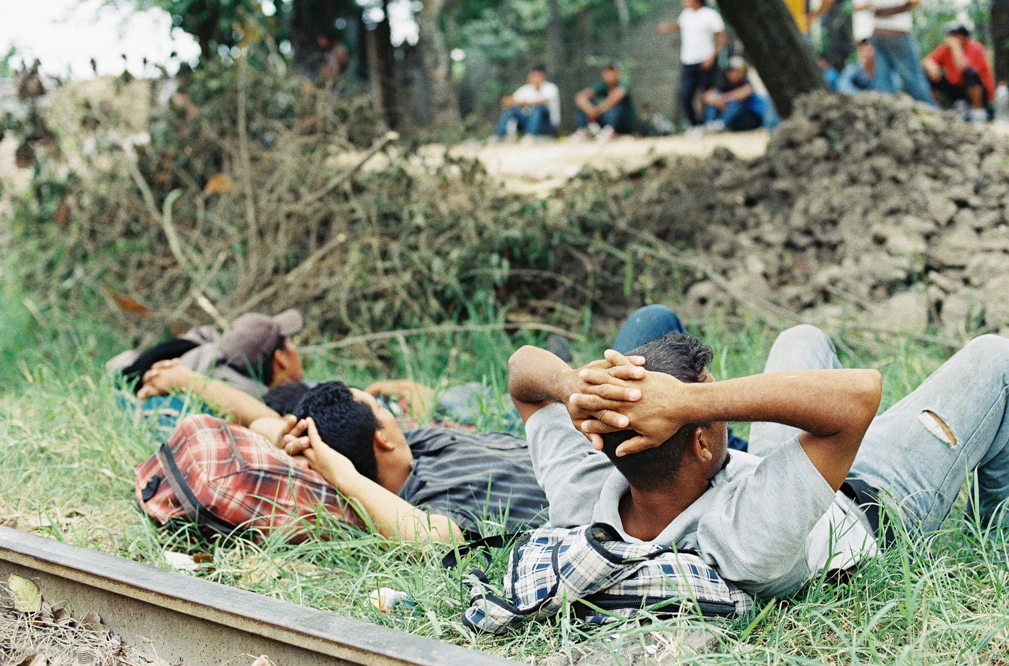 As part of his field work, anthropologist Jason De León took thousands of photographs documenting the lives of smugglers in Mexico. This image from 2017 shows a group of young Central American migrants and smugglers on the train tracks in Pakal-Ná, Mexico, a key migrant crossing zone in the southern state of Chiapas.