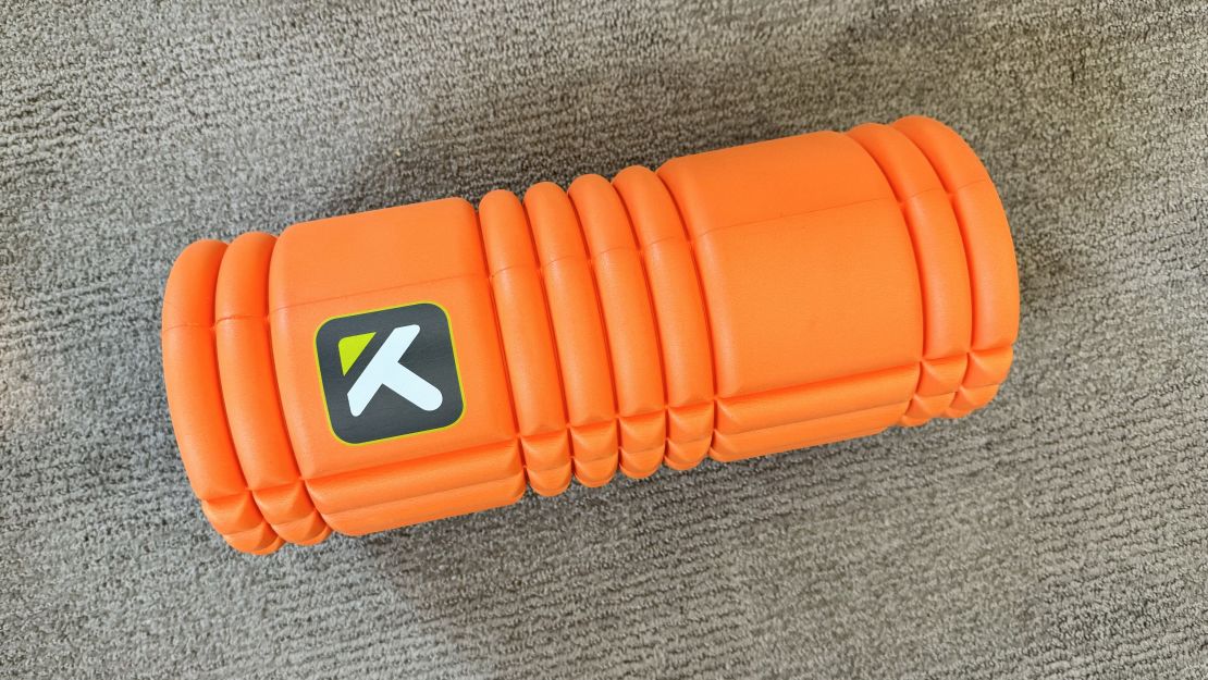 The Trigger Point Grid 1.0 Foam Roller on a carpet surface.