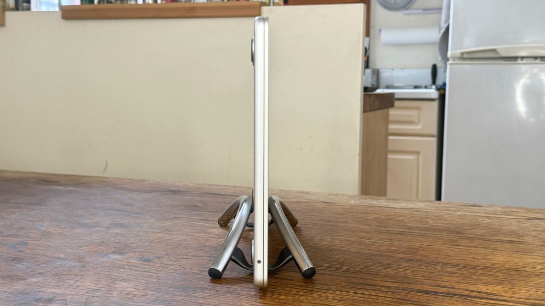 A MacBook stands upright in the chrome Twelve South BookArc Flex, seen from the side.