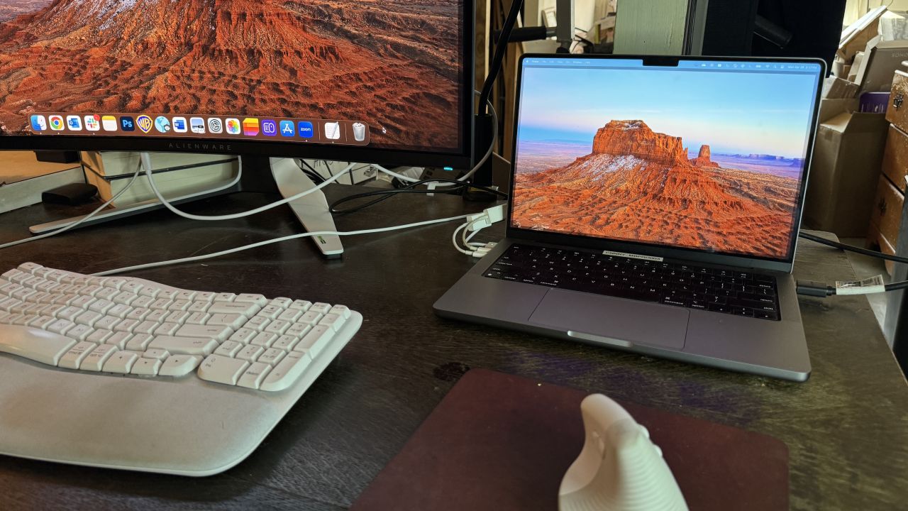 A MacBook is open normally at a desk, taking up more space.