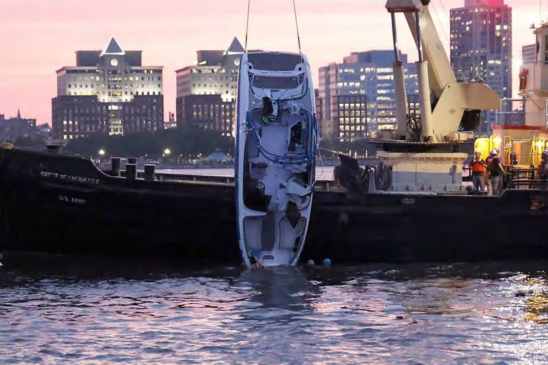 The boat, Stimulus Money, is recovered from the Hudson River by the US Army Corps of Engineers and the NYPD.
